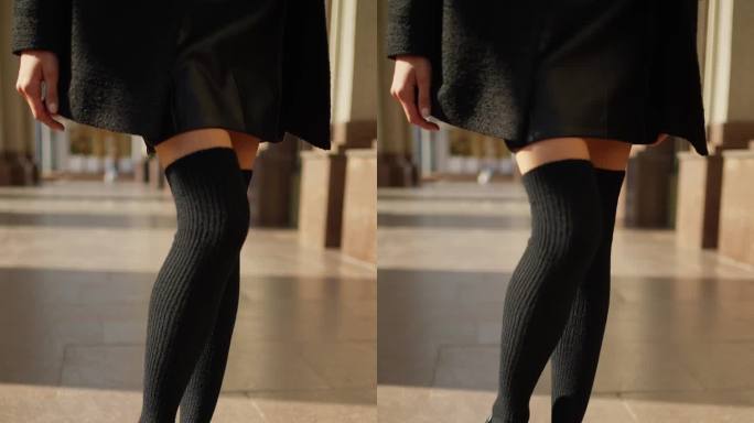 穿着黑色长袜和短裙的女性腿