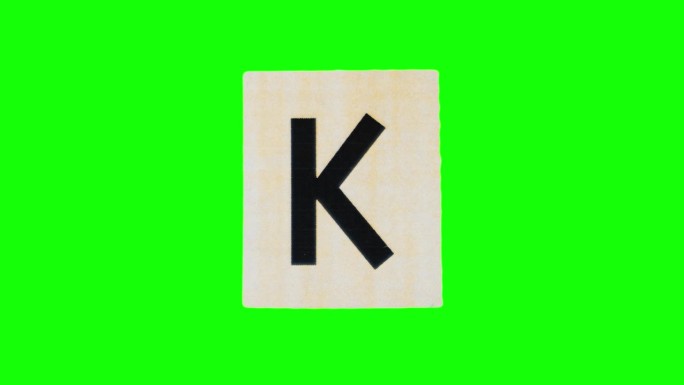 撕开的纸张上的小写字母k在对alpha通道的停止运动中拍摄