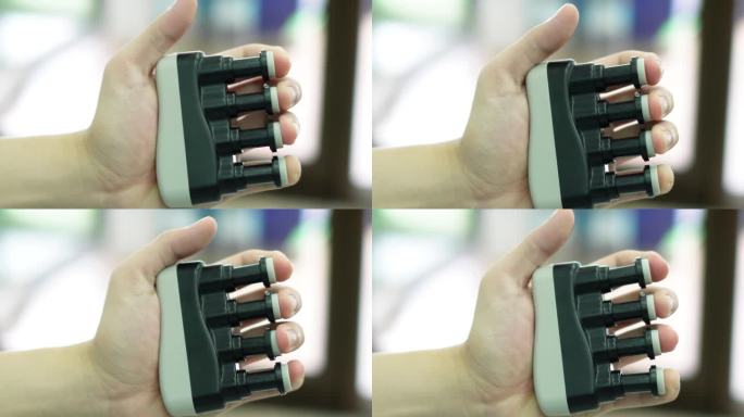 视频图像的物理治疗师使用小号式的手指锻炼装置在诊所。
