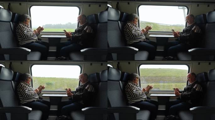 老年夫妇在火车上玩智能手机