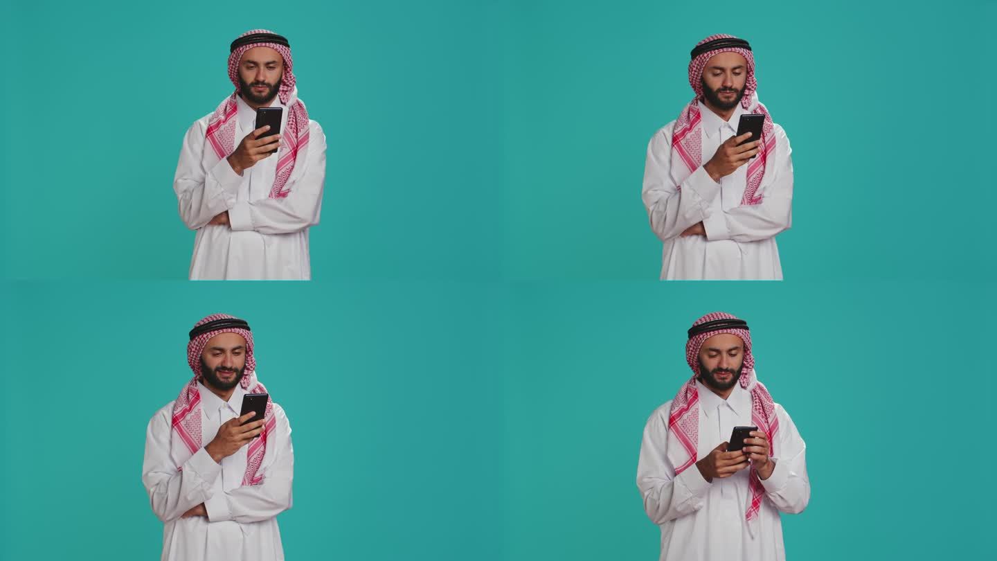 穿着服装的穆斯林男子使用智能手机