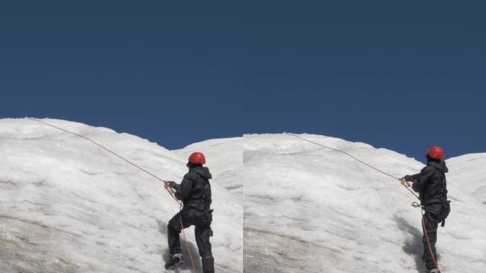 戴着冰爪和头盔的登山队员在山坡上使用固定绳上的上升器。垂直视频