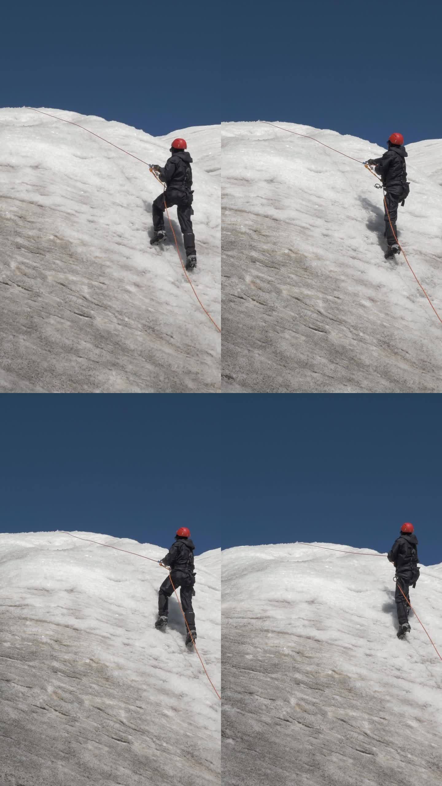 戴着冰爪和头盔的登山队员在山坡上使用固定绳上的上升器。垂直视频