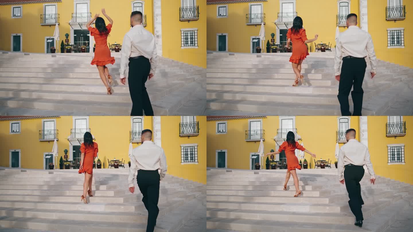 热情的西班牙夫妇在街上的楼梯上跳着拉丁风格的热舞