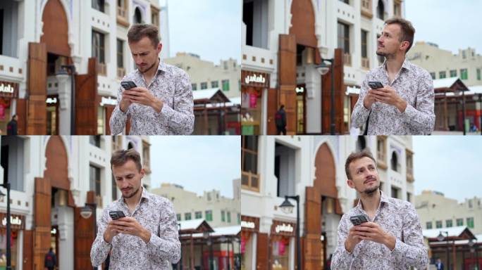 男游客在科威特市用智能手机查找路线