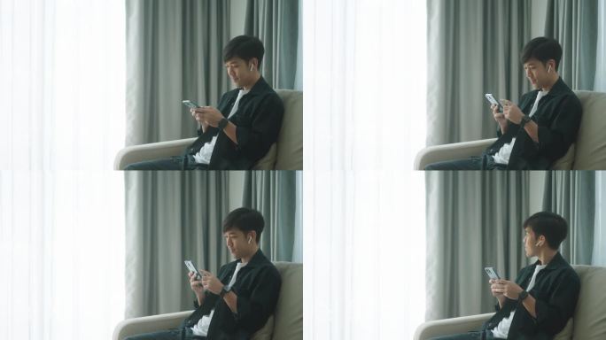 一名亚洲男子在家使用智能手机