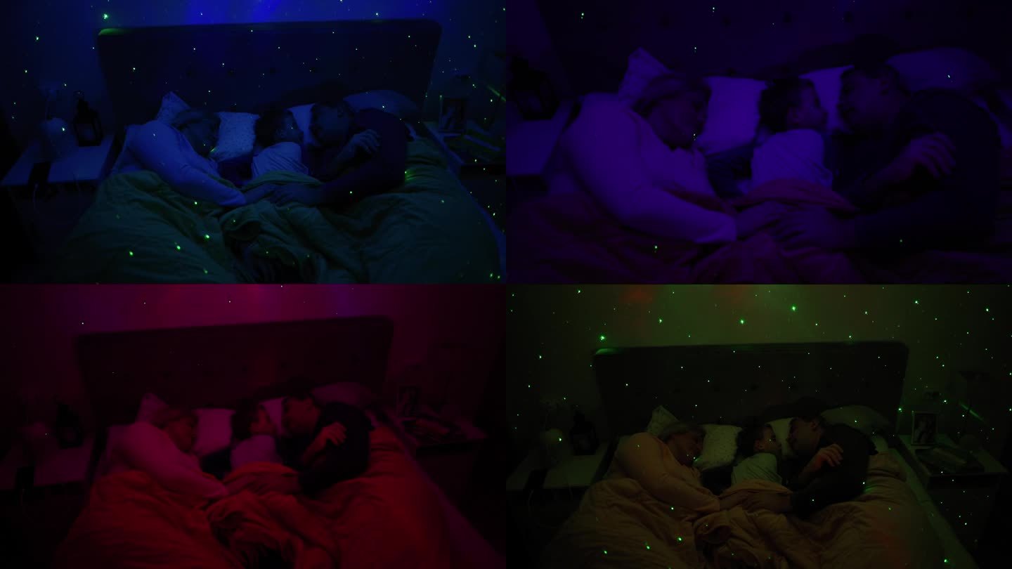 白人家庭，父母带着儿子睡在床上，床上有一盏白噪音RGB灯，灯上的星星在墙上投射