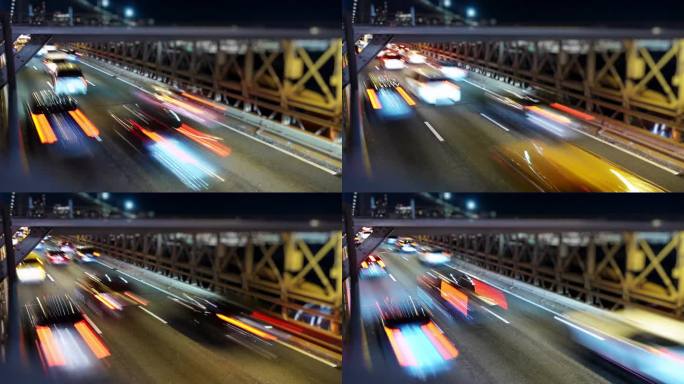 布鲁克林大桥夜间交通情况。一场迷人的灯光和动作交响乐，捕捉了纽约城市生活的活力脉搏。