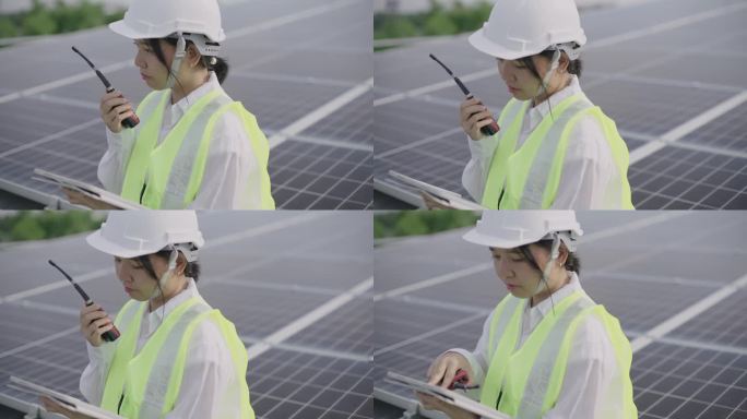 工程师在太阳能发电站使用数码平板电脑。