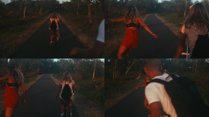 三个朋友在乡间路上骑自行车和滑板