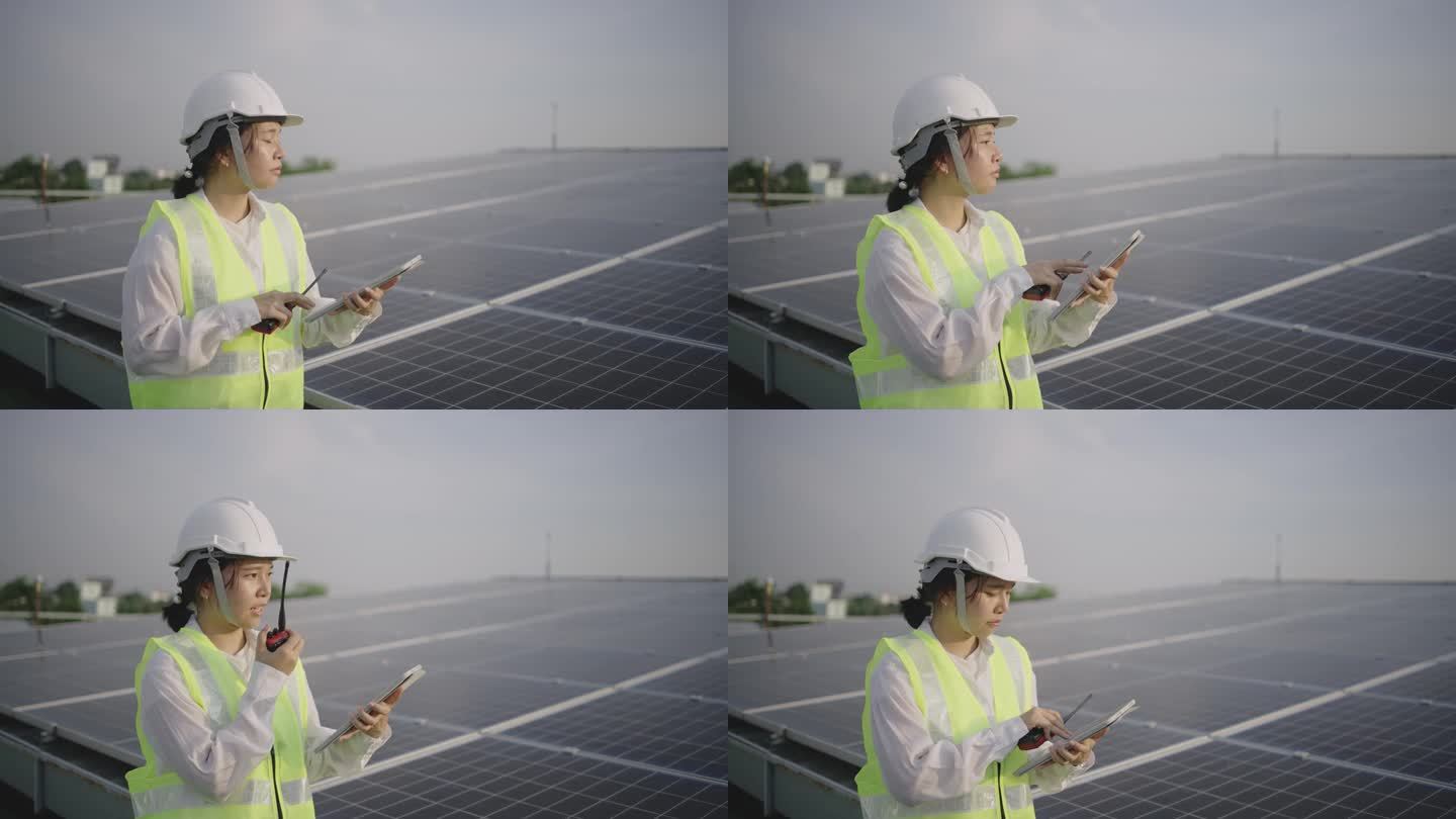 在太阳能发电站现场工作的维护工程师手持数码平板电脑。