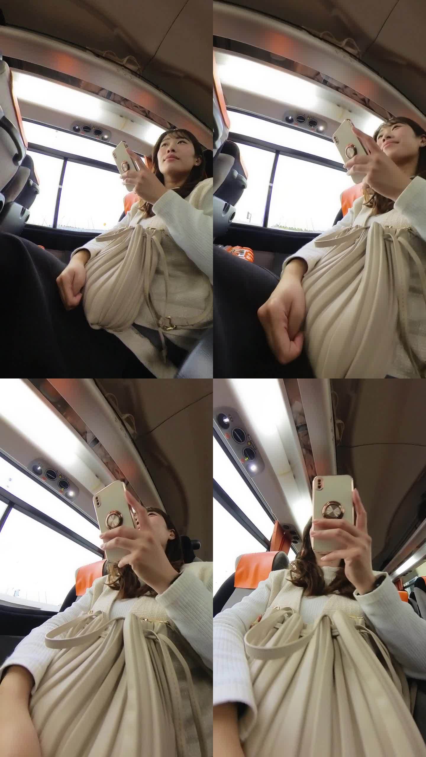 女商人在机场巴士上使用智能手机