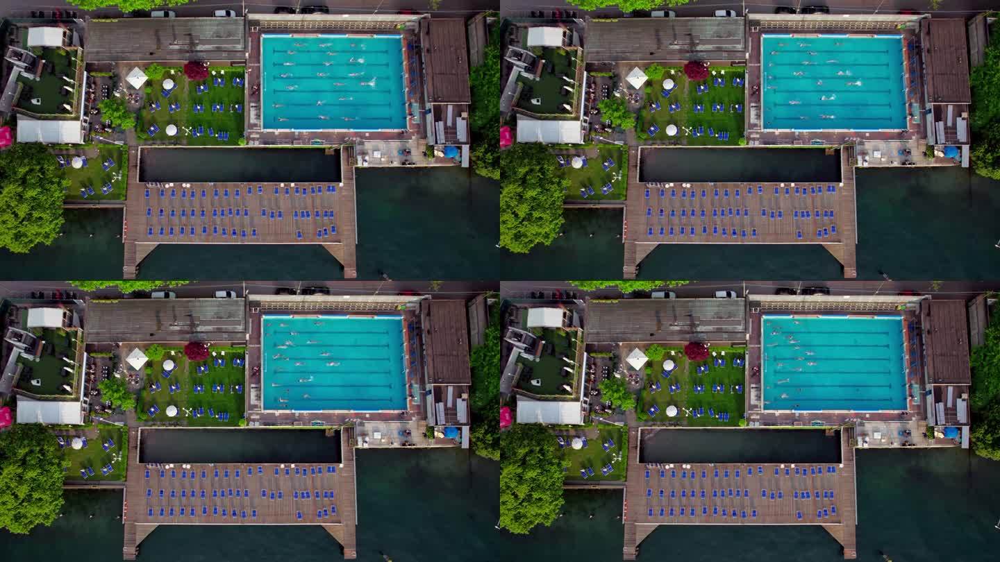从上到下，人们在科莫湖有餐厅和码头的游泳池里游泳