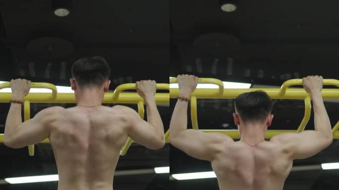 年轻的亚洲健美运动员在健身房做引体向上