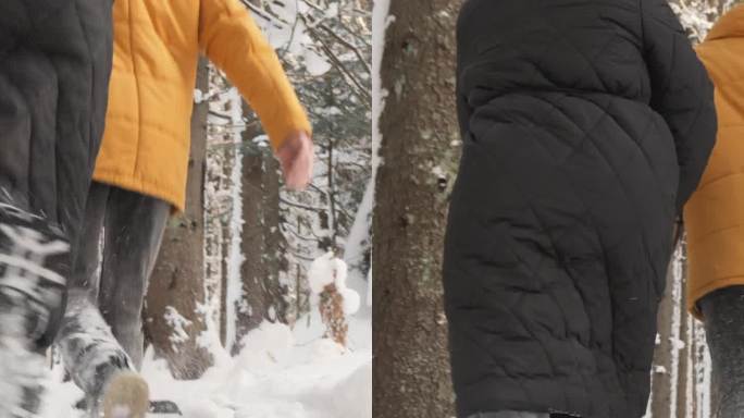 垂直视频。一对快乐的夫妇在冬天晴朗的天空下在森林里玩耍和享受时光，盖伊和女朋友手牵手在雪地里奔跑