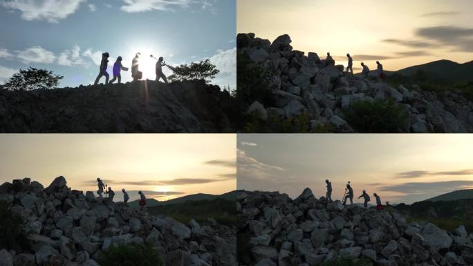 登山攀岩勘测协同合作夕阳剪影航拍脚步