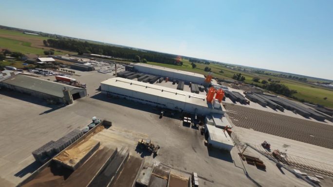 无人机飞行查看满是混凝土空心砖的大型物料仓库