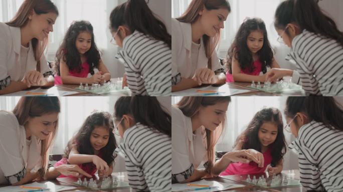 多种族小学生一起下跳棋，美丽的亚洲女老师在小学课堂上指导和教授跳棋课。