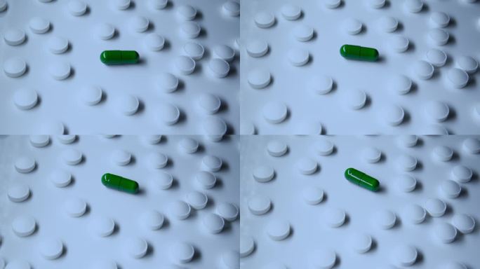 绿色胶囊周围环绕着其他传统的白色药片、医疗处方、有活性物质和没有活性物质的药物
