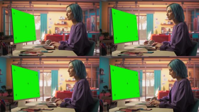 弧线拍摄肖像美丽的时尚女人与蓝头发微笑，而使用现代桌面电脑与绿屏模拟显示。创意女性查看社交媒体和在线