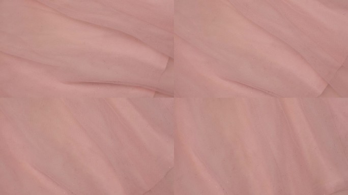 柔软的雪纺细节纹理。天然网眼织物近距离编织图案。粉红光聚酯表面。旋转,宏。舒适的纺织背景。衣服的生产