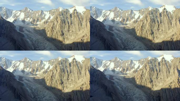 从阿克赛冰川的高处俯瞰。风景如画的山景。吉尔吉斯斯坦美丽的雪山、山脊、丘陵和岩石。