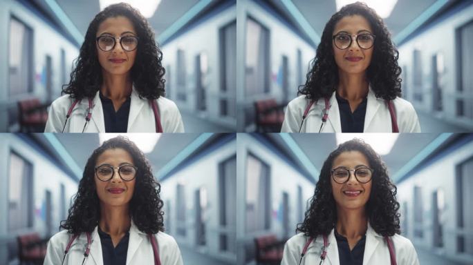 一个美丽的医疗保健专业人员的肖像摆姿势，微笑着看着相机。戴眼镜穿白大褂的多民族门诊医生在现代医院工作