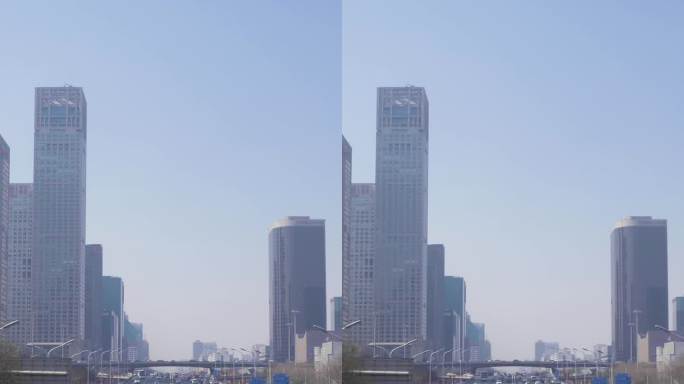 晴朗的一天，中国北京中央商务区。摩天大楼和道路上的汽车交通。垂直视频