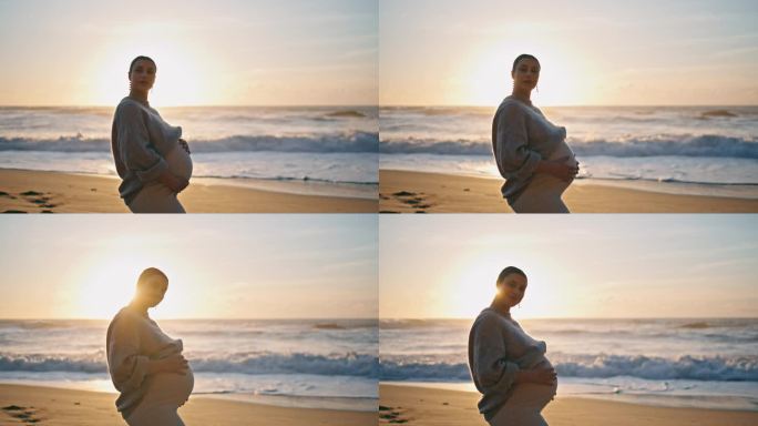 怀孕的女孩站在夕阳下紧紧抱着肚子。未来妈妈在海滩摆姿势