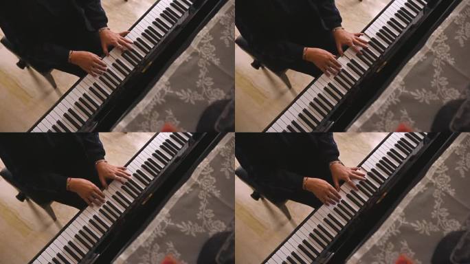 从上面看，女钢琴家在室内弹钢琴时把手指放在钢琴键上