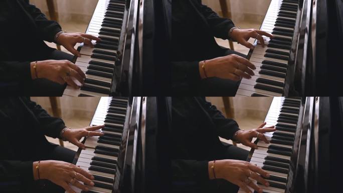 钢琴家弹奏钢琴时双手的缓慢动作。音乐家手指在钢琴键上的特写