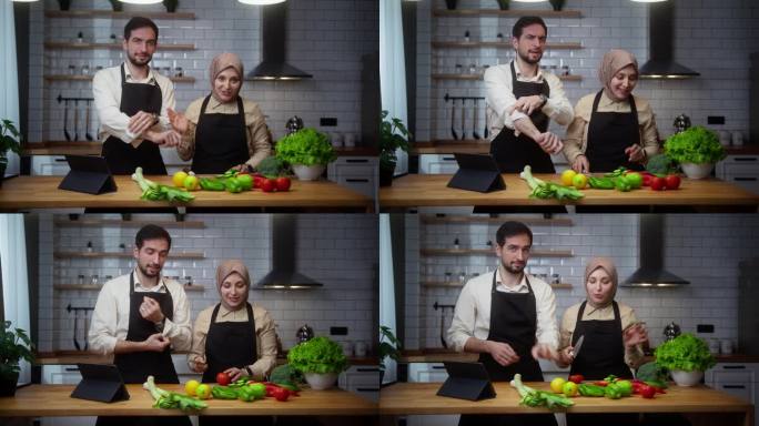视频博主年轻夫妇厨师在围裙录制视频烹饪课关于素食餐或沙拉在家里的现代厨房