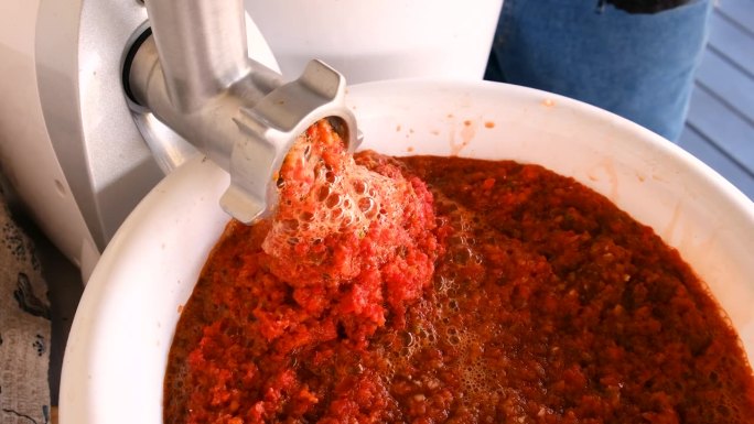 用电动绞肉机磨红辣椒。选择聚焦。食物。