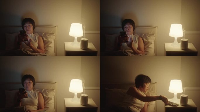 成熟的女人关掉智能手机和灯睡觉。