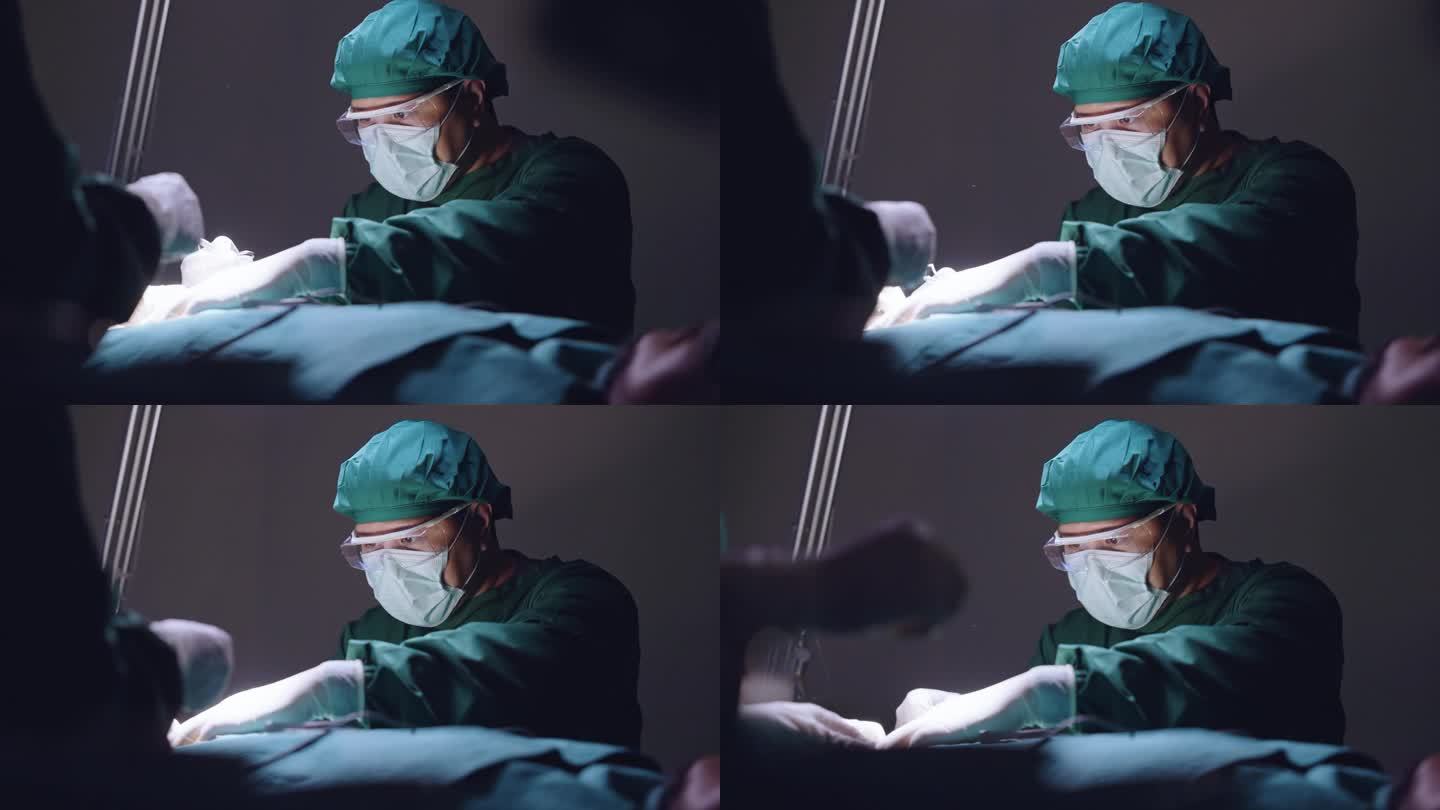 在昏暗的手术室里，一名外科医生在他的团队的帮助下，表情严肃地为病人做手术缝合。