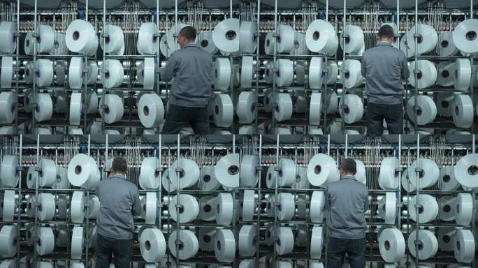 男性纺织工人在化纤纺织厂车间工作