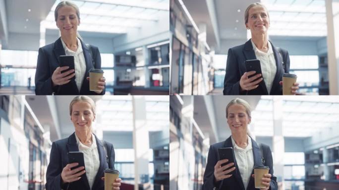 一个白人女人的肖像，她用智能手机，走在空荡荡的办公大厅里，面带微笑。一位穿着时髦休闲装的女商人，端着