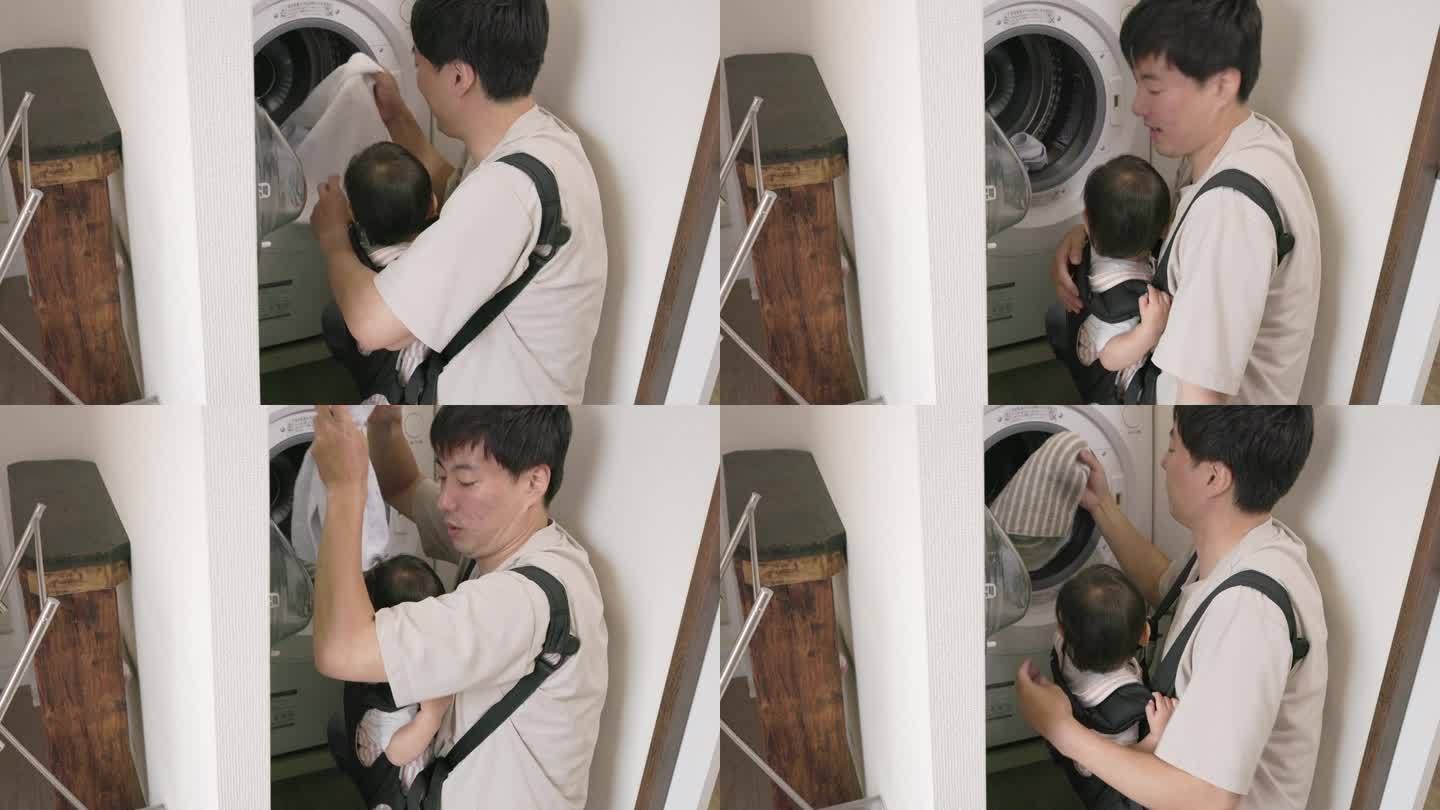 父亲抱着孩子洗完毛巾，从洗衣机里拿出毛巾。