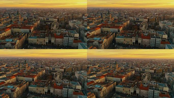 在日落时分，匈牙利布达佩斯拥挤的城市景观中，摩天轮和圣斯蒂芬大教堂的空中无人机镜头