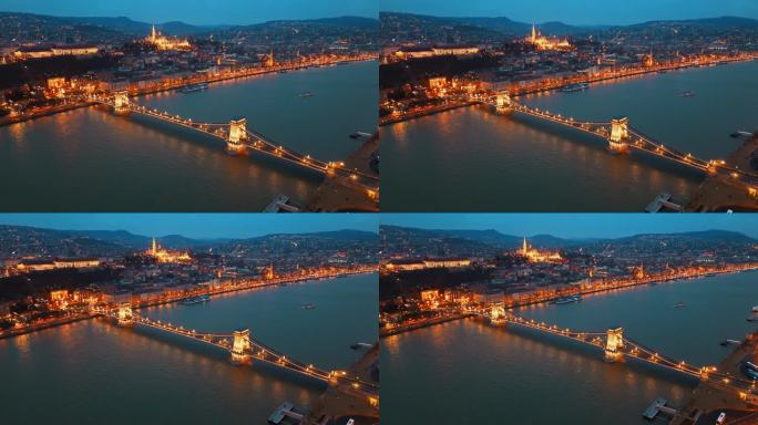 在匈牙利布达佩斯的多瑙河上，黄昏时分，被照亮的sz<s:1> chenyi链桥的空中无人机镜头