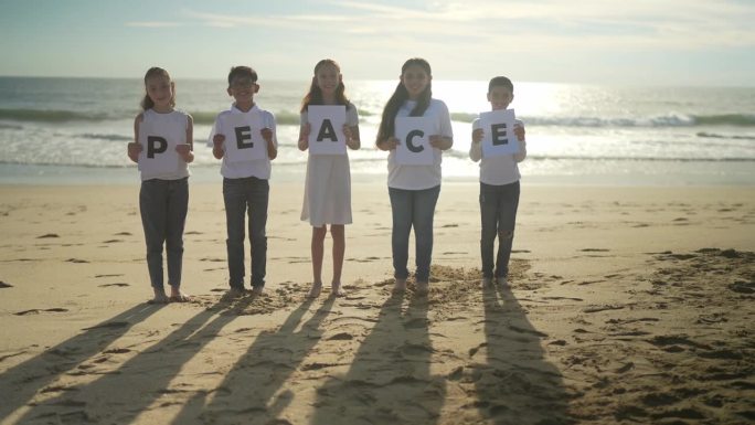 孩子们在海滩上举着和平海报的肖像