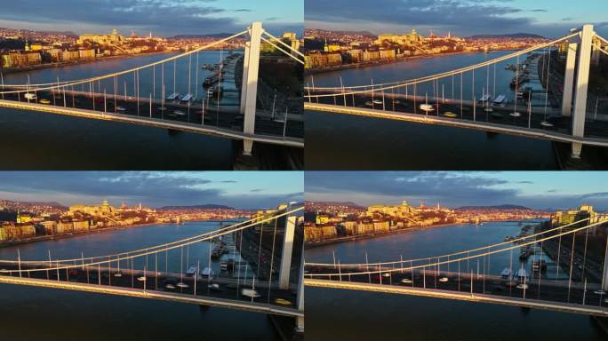 移动模糊空中无人机镜头的车辆在多瑙河上的伊丽莎白桥在日落期间在匈牙利布达佩斯