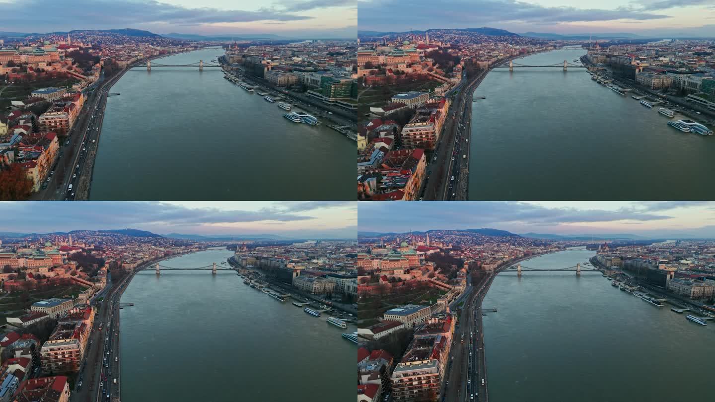 空中无人机拍摄的szacimchenyi链桥在多瑙河上的城市景观在日落，匈牙利布达佩斯