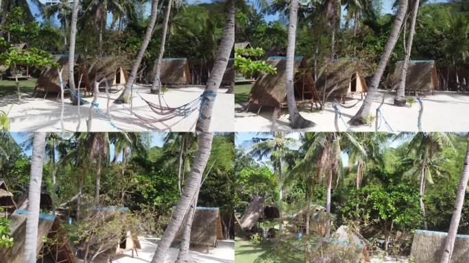 热带白色沙滩上的生态高跷小屋和棕榈树吊床