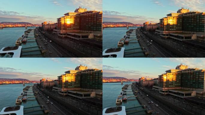 船只停泊在多瑙河码头的建筑物对天空在日落期间在布达佩斯，匈牙利