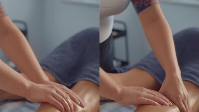 专业的水疗沙龙腿部按摩。近距离妇女得到油放松深层组织小腿肌肉按摩。垂直方向视频