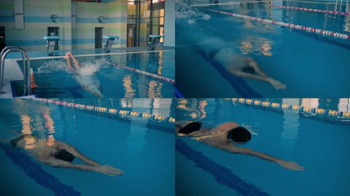 肌肉发达的游泳运动员在清澈的池水中从领奖台上跳下来