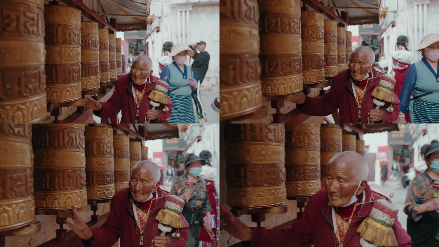 西藏诵经转经筒的藏民老人