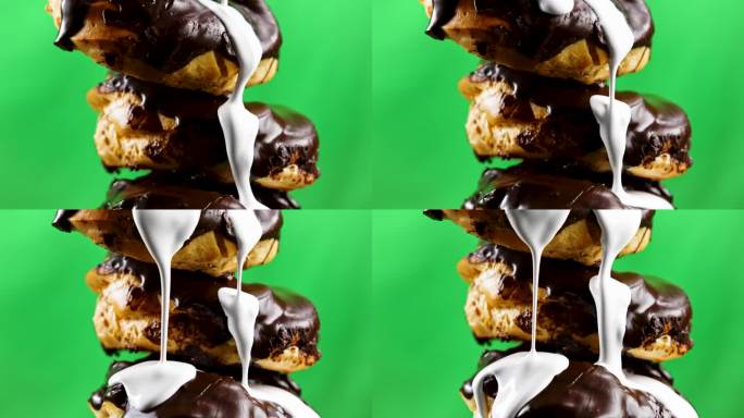 巧克力糖衣烤曲奇。股票剪辑。绿色的背景上，新鲜的甜饼干和巧克力浇上了蛋奶沙司。高品质4k画面