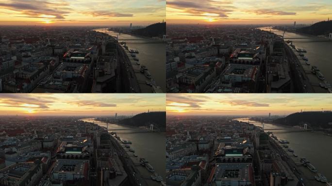 空中无人机拍摄的城市景观多瑙河对天空在日落期间在布达佩斯，匈牙利